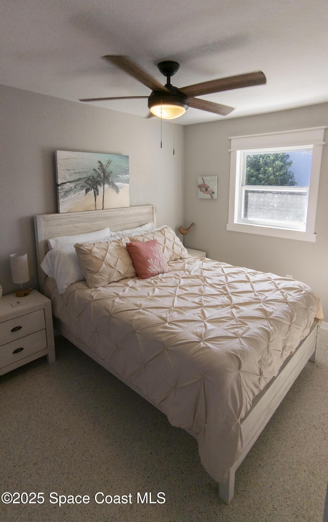 bedroom with speckled floor and ceiling fan