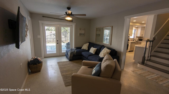 living room with a ceiling fan, recessed lighting, french doors, baseboards, and stairs