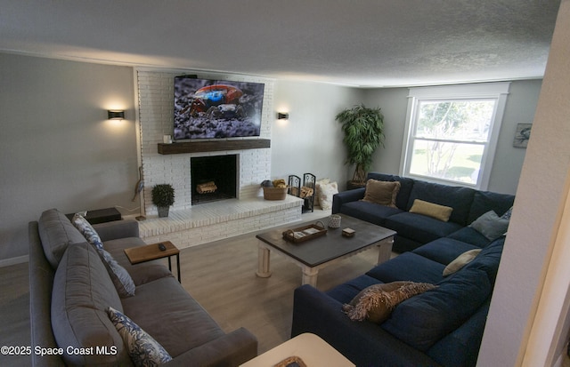 living room featuring wood finished floors, a fireplace, and a textured ceiling