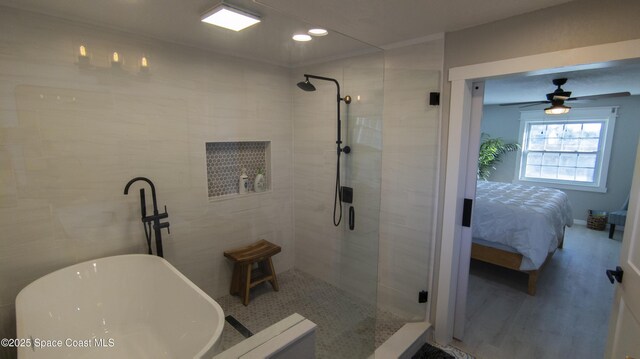 ensuite bathroom with wood finished floors, ensuite bath, a soaking tub, recessed lighting, and a tile shower