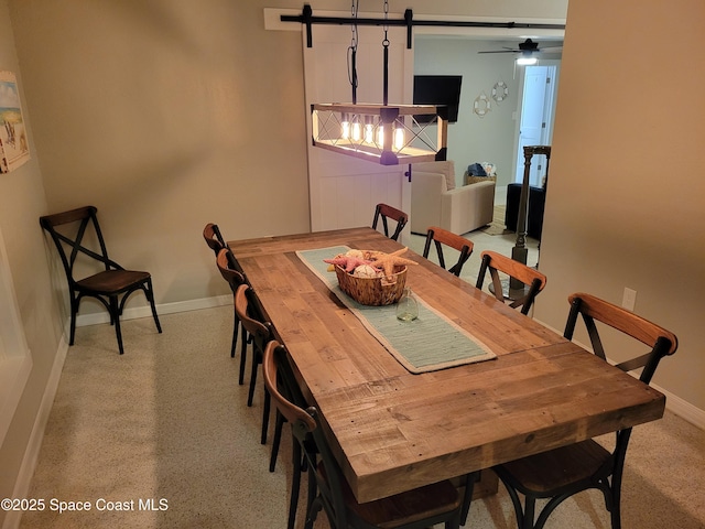 dining area featuring speckled floor and baseboards