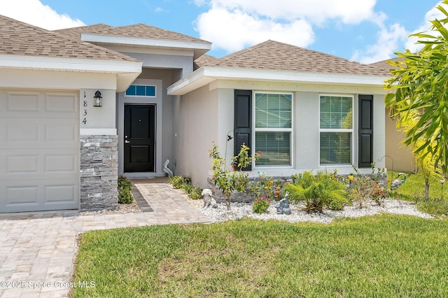 1834 Middlebury Dr, Palm Bay, FL 32909 - entrance to property featuring stone siding, a garage, roof with shingles, and stucco siding