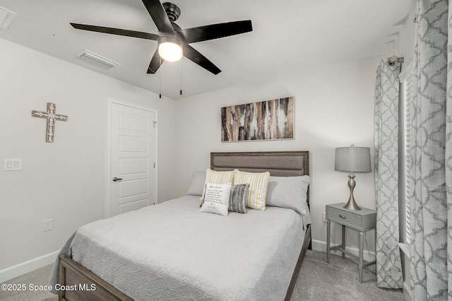 carpeted bedroom with visible vents, baseboards, and ceiling fan