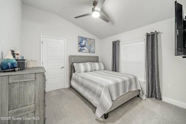 bedroom with light carpet, ceiling fan, baseboards, and lofted ceiling