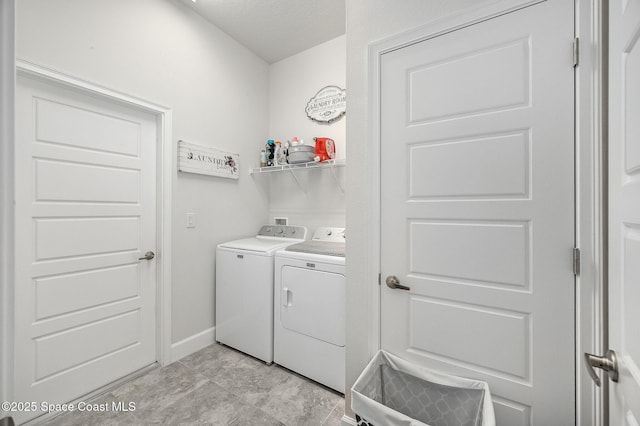 laundry area with baseboards, independent washer and dryer, and laundry area