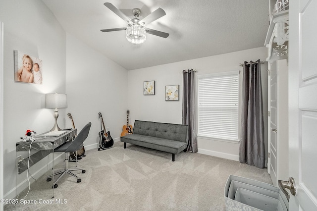 office area featuring lofted ceiling, baseboards, carpet floors, and ceiling fan