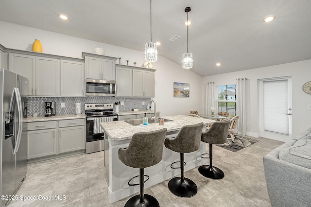 kitchen featuring gray cabinetry, appliances with stainless steel finishes, and a sink