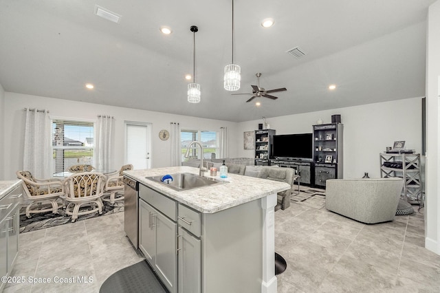 kitchen with visible vents, a sink, gray cabinetry, light countertops, and stainless steel dishwasher