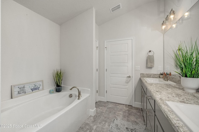 full bath with a sink, visible vents, a garden tub, and double vanity