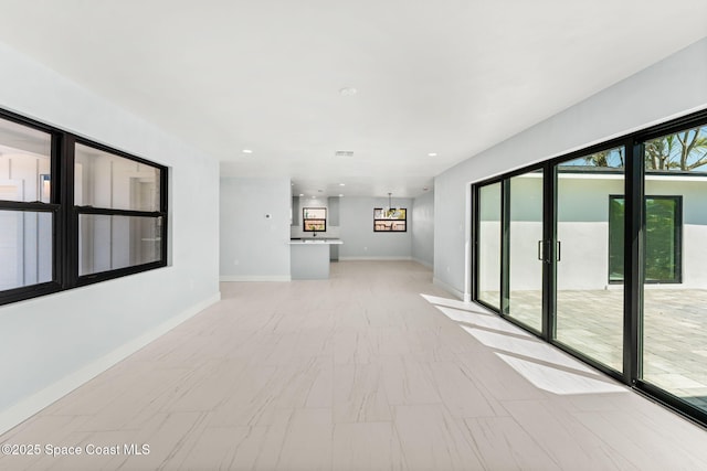 empty room featuring recessed lighting and baseboards