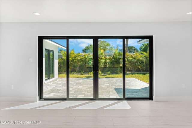 doorway featuring recessed lighting and baseboards