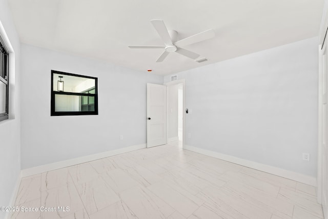 empty room with visible vents, ceiling fan, and baseboards