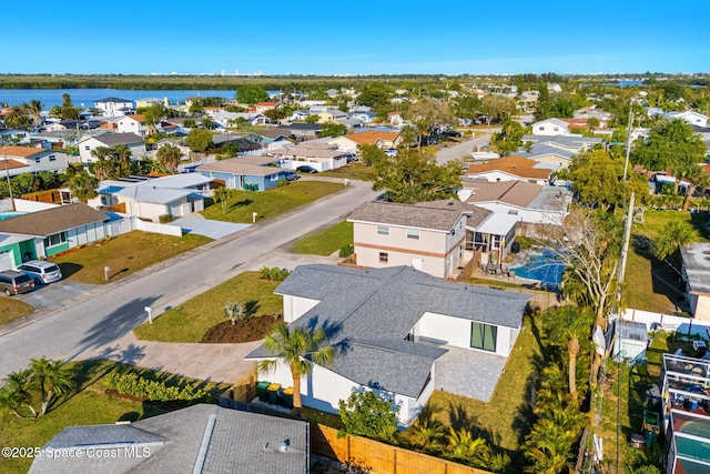 birds eye view of property with a residential view and a water view