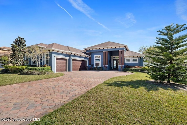 view of front of property featuring decorative driveway, a front yard, an attached garage, and stucco siding