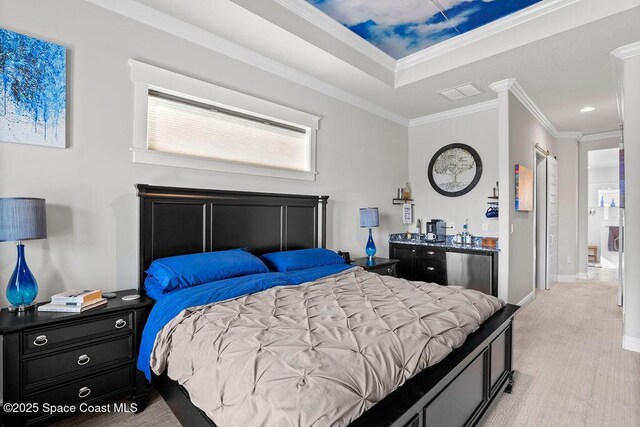 bedroom with visible vents, crown molding, fridge, light wood-style flooring, and a raised ceiling