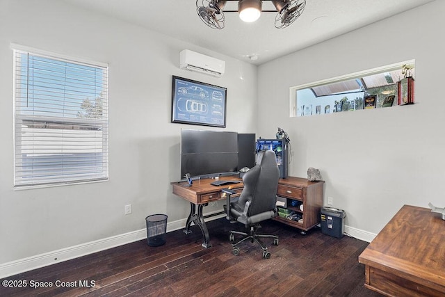 office space featuring an AC wall unit, wood finished floors, baseboards, and a chandelier