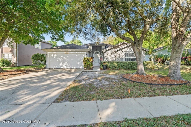 single story home featuring an attached garage, driveway, and stucco siding