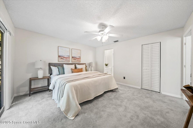 bedroom featuring visible vents, a ceiling fan, a textured ceiling, baseboards, and light colored carpet