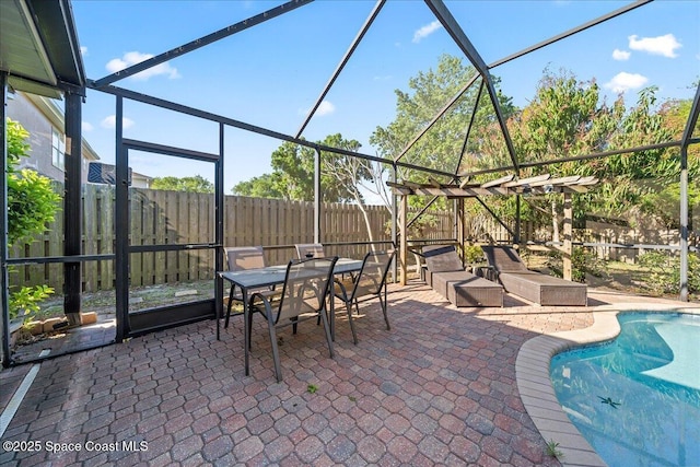 view of patio / terrace featuring glass enclosure, a fenced in pool, a fenced backyard, and outdoor dining space