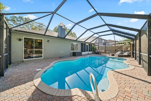 pool featuring a lanai, a patio, and fence