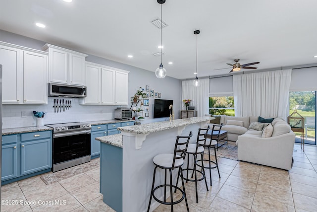 2705 Revolution St Unit 106, Melbourne, FL 32935 - kitchen with open floor plan, blue cabinetry, stainless steel appliances, and ceiling fan