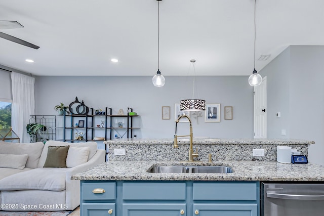 2705 Revolution St Unit 106, Melbourne, FL 32935 - kitchen featuring light stone counters, a sink, stainless steel dishwasher, blue cabinets, and open floor plan
