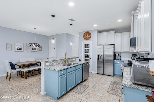 2705 Revolution St Unit 106, Melbourne, FL 32935 - kitchen featuring visible vents, backsplash, blue cabinetry, stainless steel appliances, and a sink