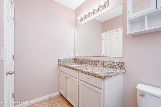 2705 Revolution St Unit 106, Melbourne, FL 32935 - half bath featuring tile patterned flooring, toilet, vanity, and baseboards