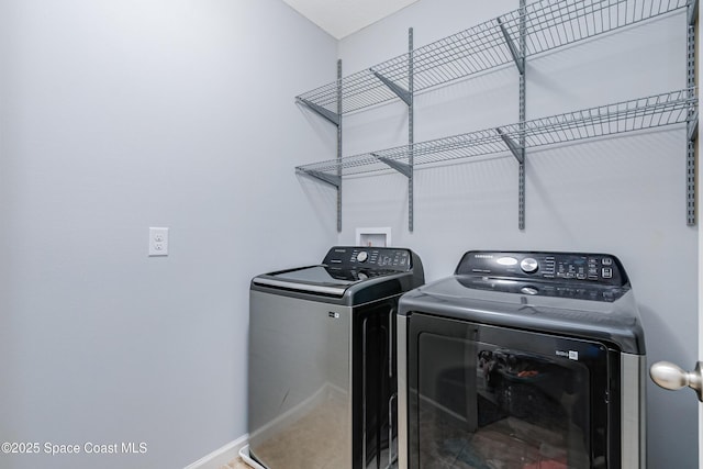 2705 Revolution St Unit 106, Melbourne, FL 32935 - clothes washing area featuring washer and dryer, laundry area, and baseboards