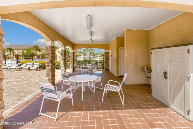2705 Revolution St Unit 106, Melbourne, FL 32935 - view of patio featuring outdoor dining space and fence