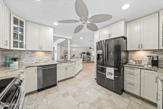 380 Greenway Ave, Satellite Beach, FL 32937 - kitchen featuring glass insert cabinets, appliances with stainless steel finishes, ceiling fan, and stone tile floors