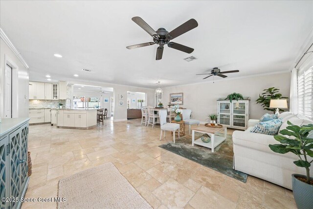 380 Greenway Ave, Satellite Beach, FL 32937 - living area with visible vents, crown molding, baseboards, ceiling fan, and stone tile floors