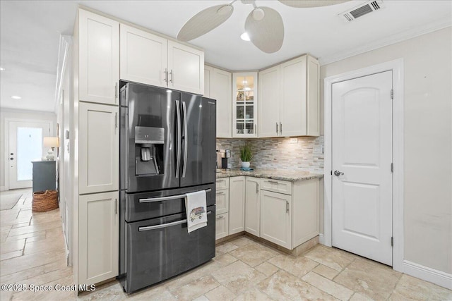 380 Greenway Ave, Satellite Beach, FL 32937 - kitchen featuring stone tile flooring, visible vents, decorative backsplash, and stainless steel fridge with ice dispenser