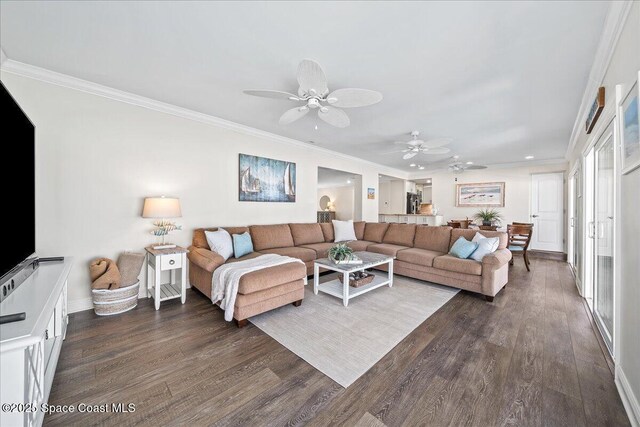 380 Greenway Ave, Satellite Beach, FL 32937 - living area featuring crown molding, baseboards, dark wood-style flooring, and ceiling fan