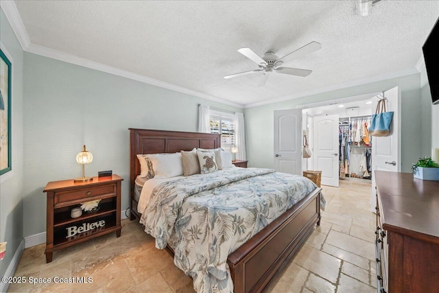 380 Greenway Ave, Satellite Beach, FL 32937 - bedroom featuring a spacious closet, crown molding, a closet, stone tile flooring, and a textured ceiling