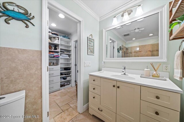 380 Greenway Ave, Satellite Beach, FL 32937 - full bath with toilet, stone tile floors, tile walls, crown molding, and vanity