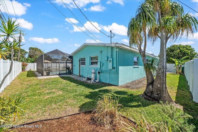 380 Greenway Ave, Satellite Beach, FL 32937 - back of property with a lanai, a yard, a fenced backyard, and stucco siding