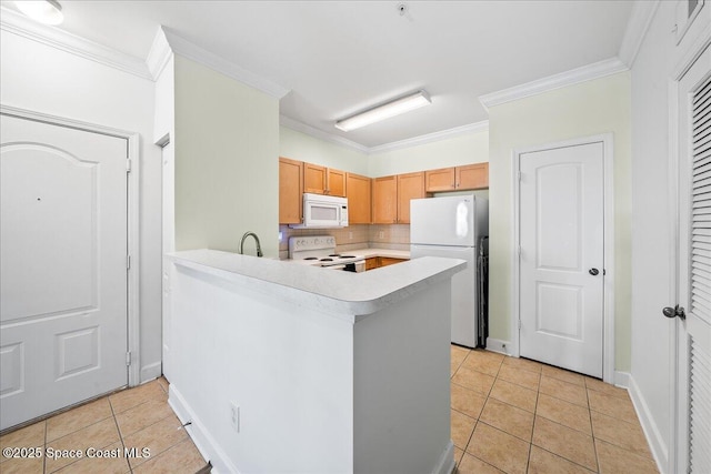 kitchen featuring light tile patterned floors, white appliances, light countertops, and ornamental molding