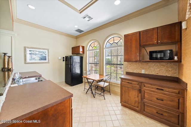 kitchen with visible vents, ornamental molding, black appliances, and a sink