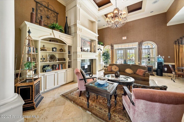 living area featuring a tiled fireplace, a chandelier, ornamental molding, a high ceiling, and coffered ceiling