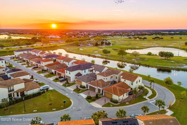 birds eye view of property with a residential view and a water view