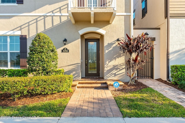 entrance to property featuring stucco siding