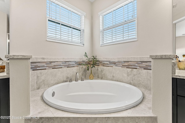 full bathroom with a garden tub and vanity