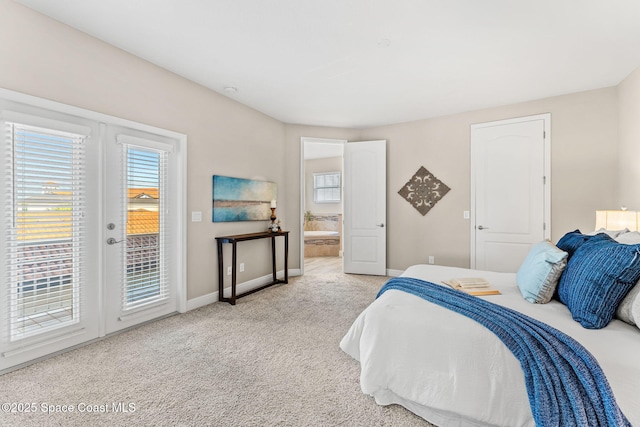 bedroom with access to exterior, multiple windows, french doors, and carpet floors