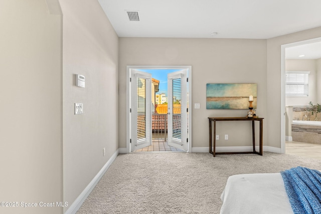 interior space with visible vents, baseboards, carpet, and connected bathroom