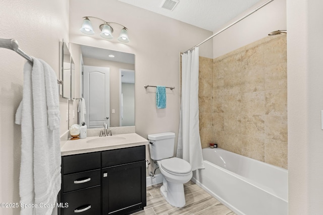 bathroom with visible vents, wood tiled floor, toilet, shower / bath combination with curtain, and vanity