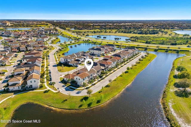 drone / aerial view featuring a residential view and a water view