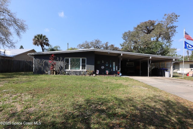 mid-century modern home with a carport, concrete driveway, fence, and a front yard