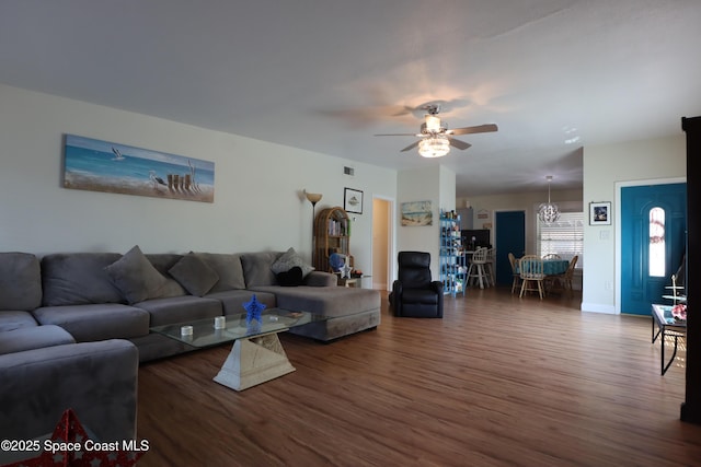 living room featuring ceiling fan, visible vents, and wood finished floors