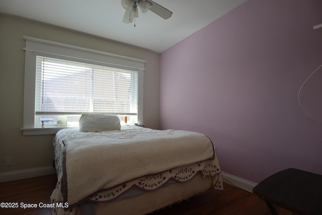 bedroom featuring vaulted ceiling, a ceiling fan, baseboards, and wood finished floors